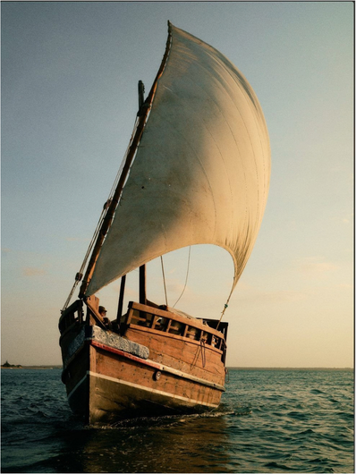 Traditional dhow boat at sea in soft morning light